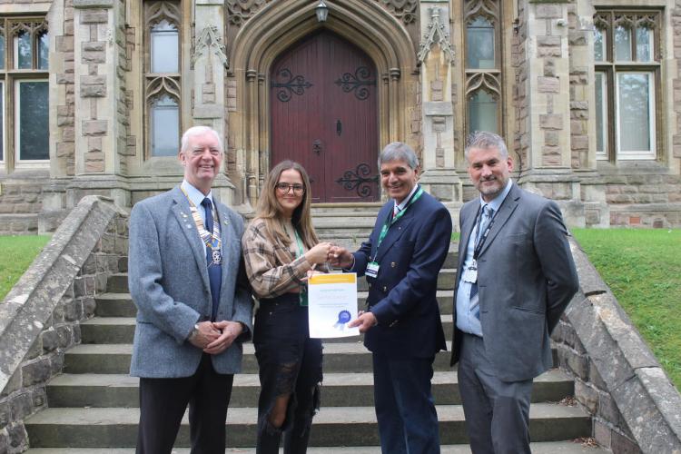 Caitlin receiving her award from Dr Gurnam Basran. On the left is President Steve Burns and on the right Joel Wirth.