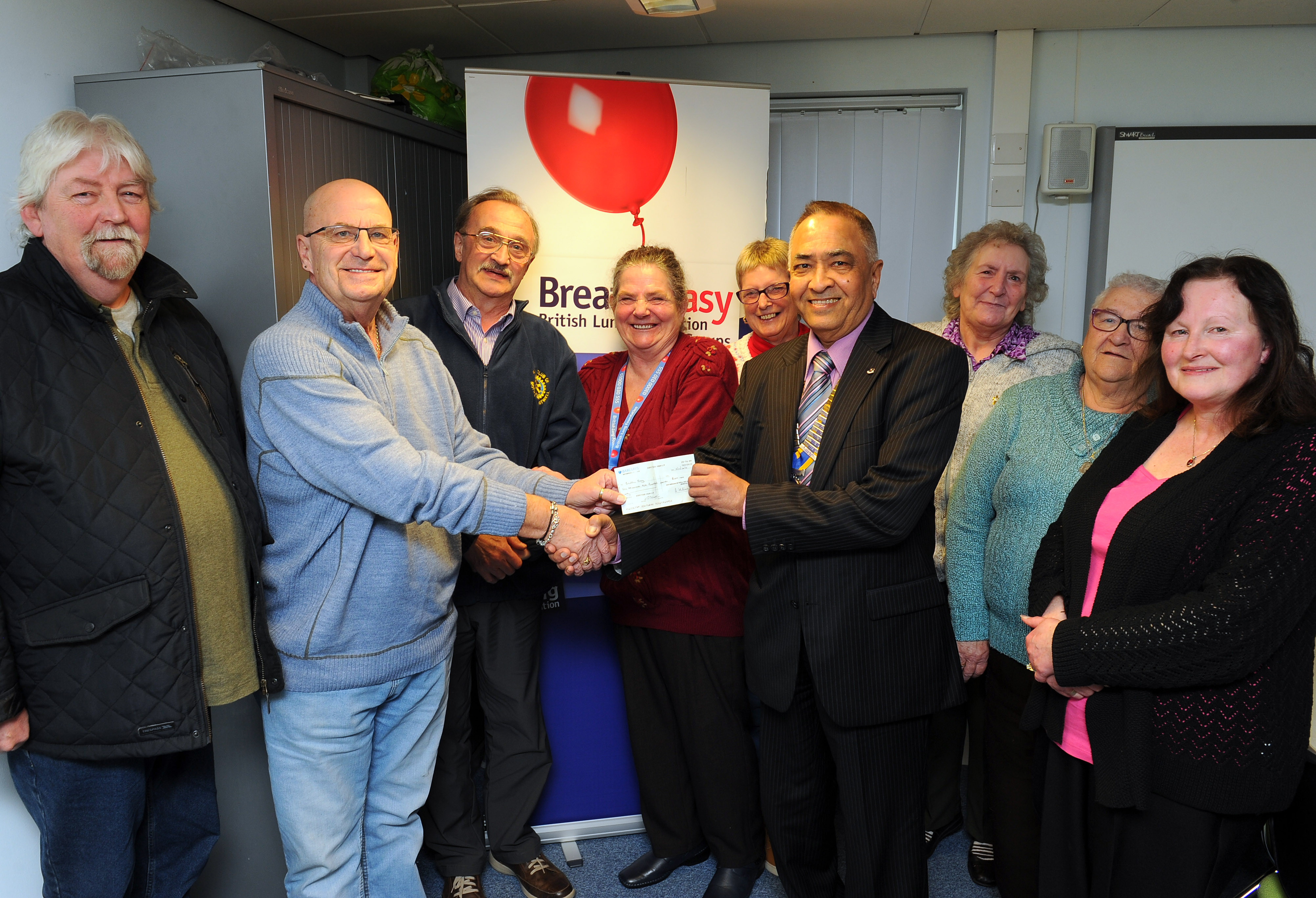 President Yogesh and Graham with Wilma Abbott (under the balloon) and other members of the Breathe Easy team. (Photo courtesy of the Rotherham Advertiser).