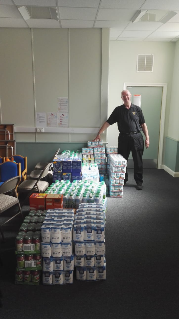 Rotarian Steve Burns with the food donation