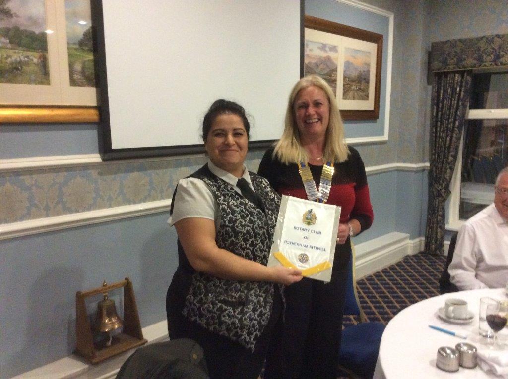 President Ann presents Lora with the Club Pennant